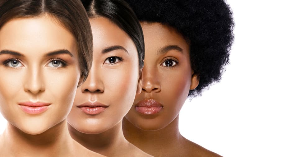 Three women with different skin tones standing side by side, representing beauty and diversity.